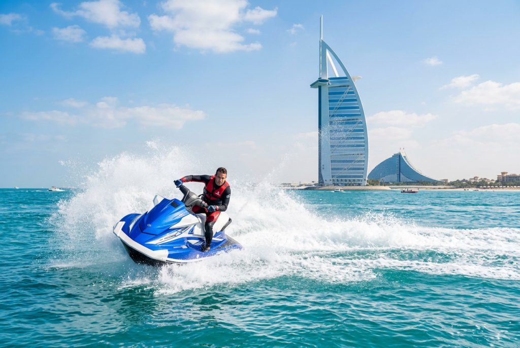 Jet ski rider speeding past the Burj Al Arab in Dubai